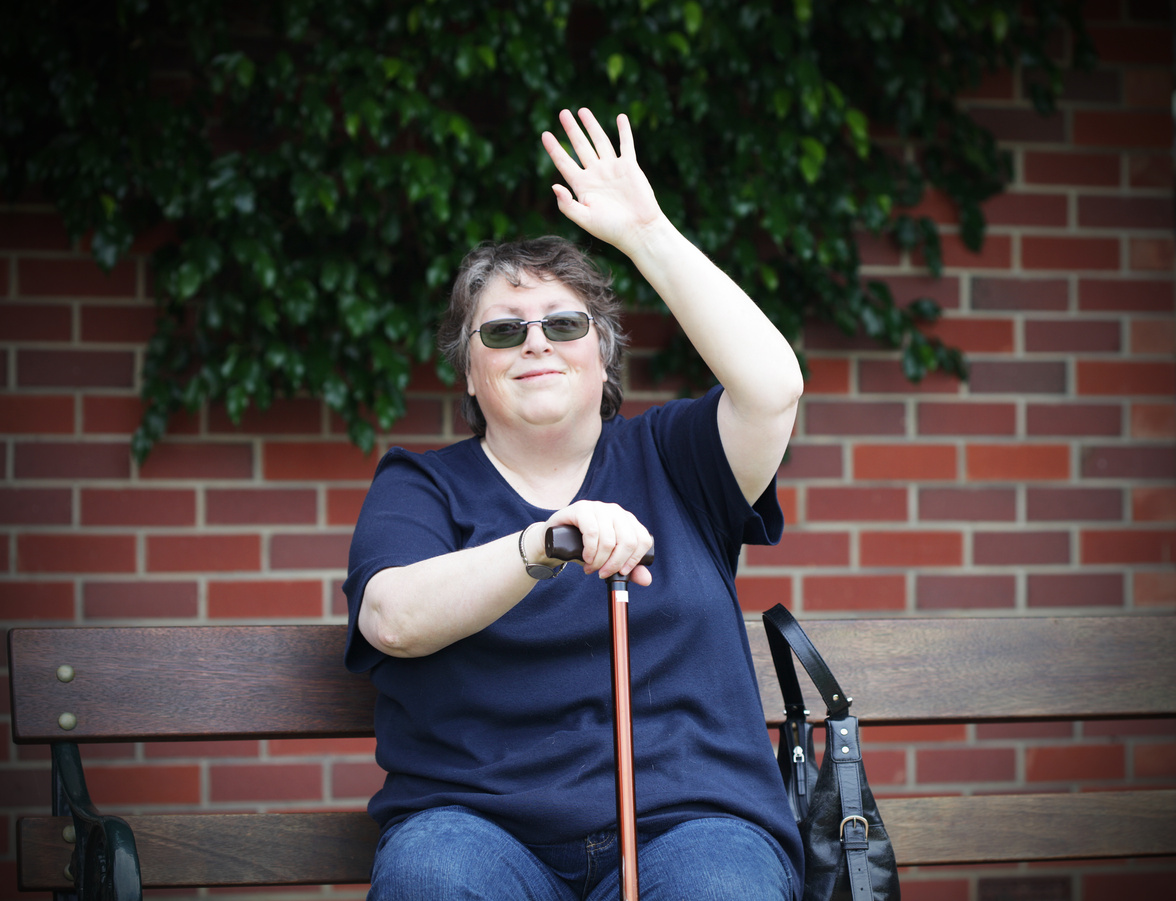 waving disabled woman