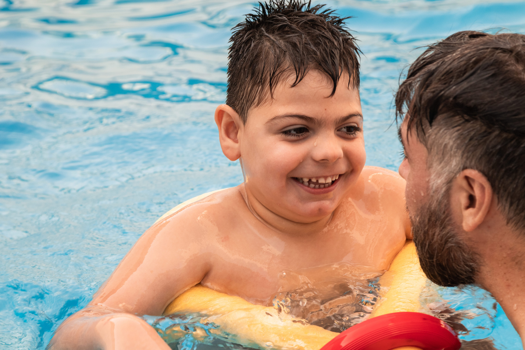 Parent Swimming with Disabled Son